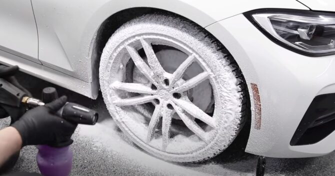 A BMW gets sprayed with AvalonKing Ceramic Prep Shampoo ahead of a deep cleaning scrub session. Photo Credit: Pan The Organizer/YouTube